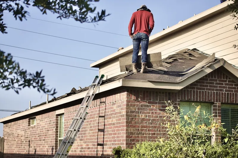 Professional roofer working on a residential roof in Seaside